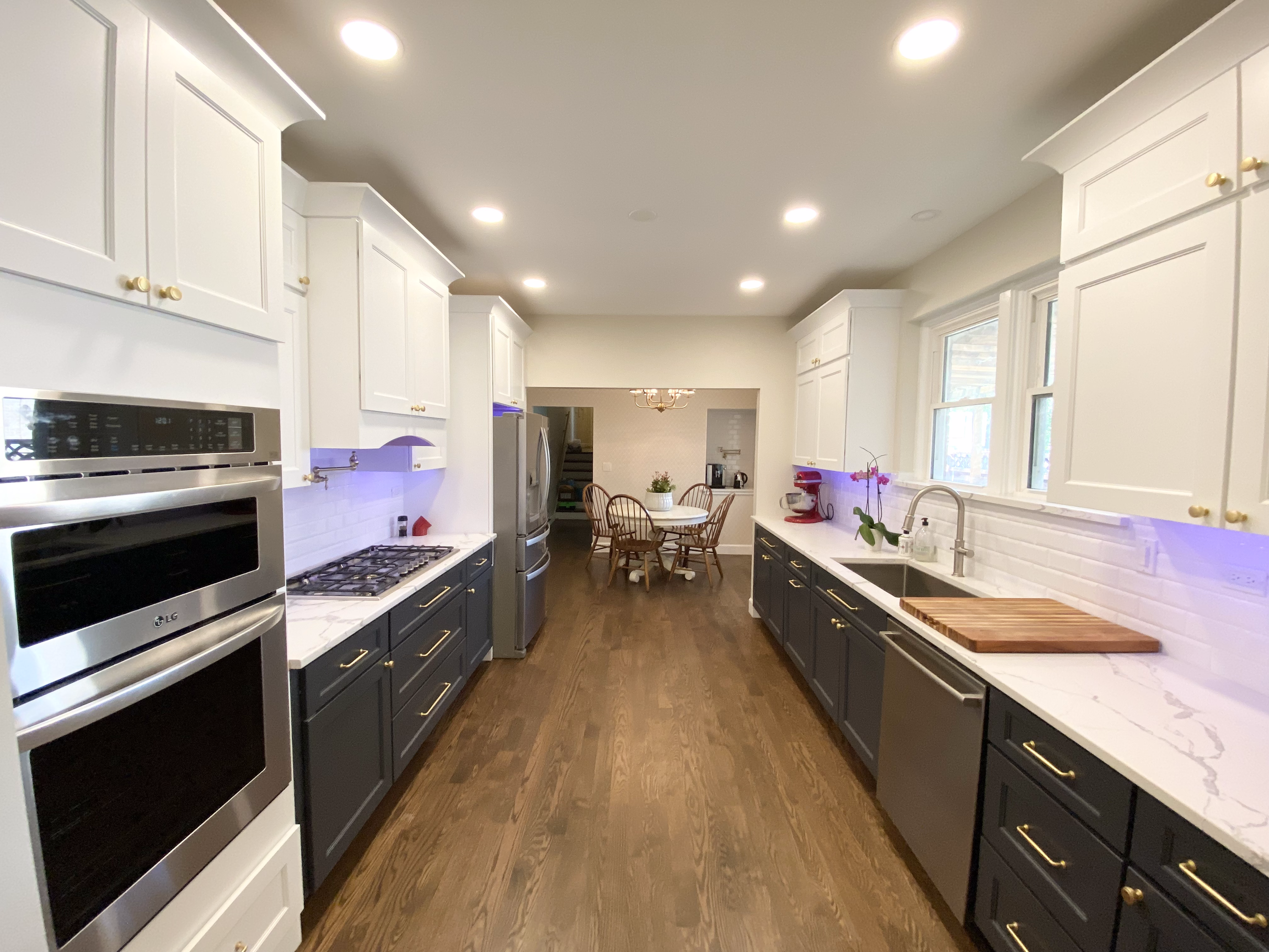 Emerald Fern Finishes sourced two-tone kitchen remodel — navy lower cabinets, white upper cabinets, quartz countertops, subway tile, and custom coffee nook in Evanston Illinois