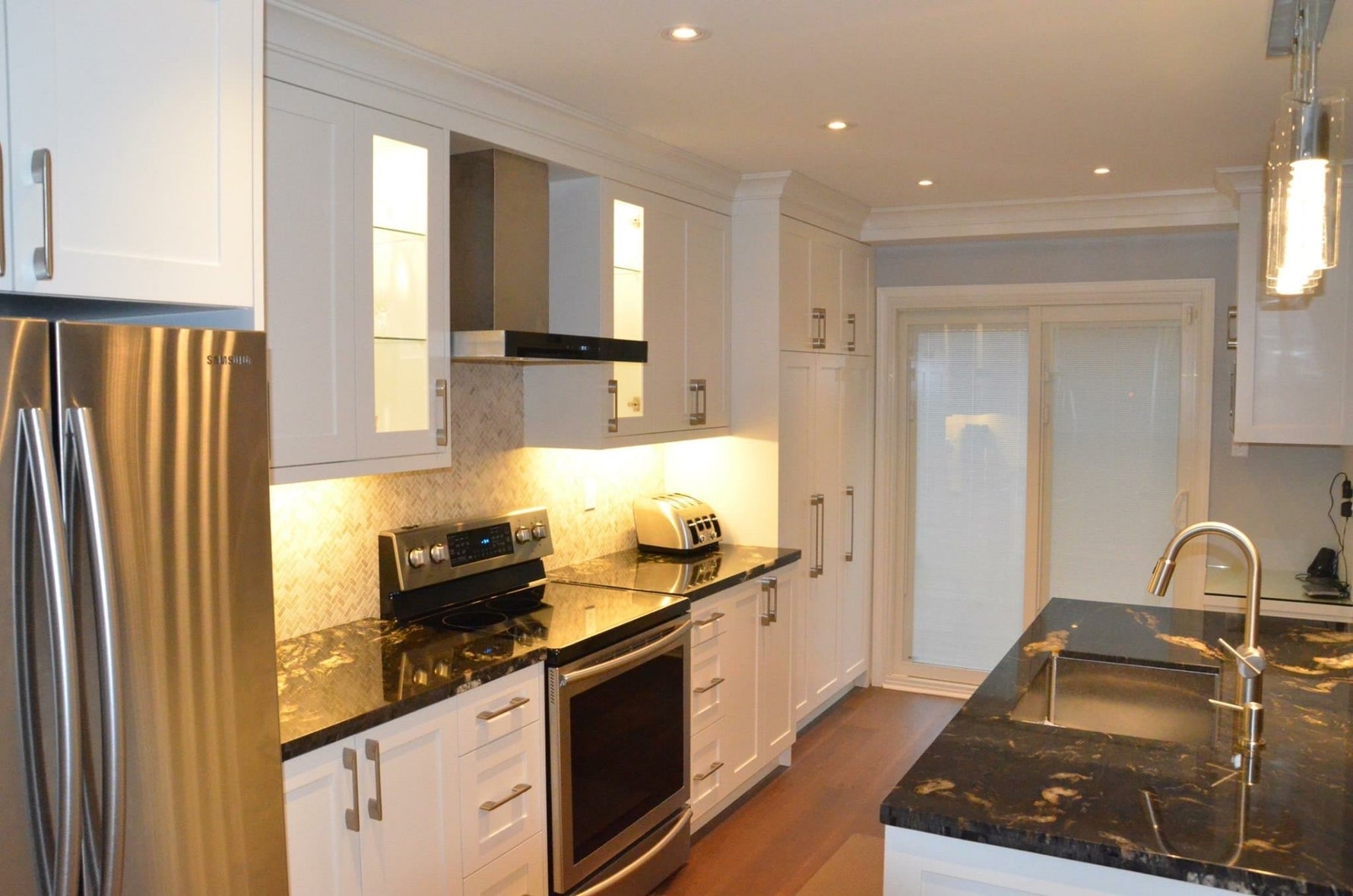 Full kitchen renovation Lake Forest IL — white shaker cabinets Mohawk hardwood flooring
