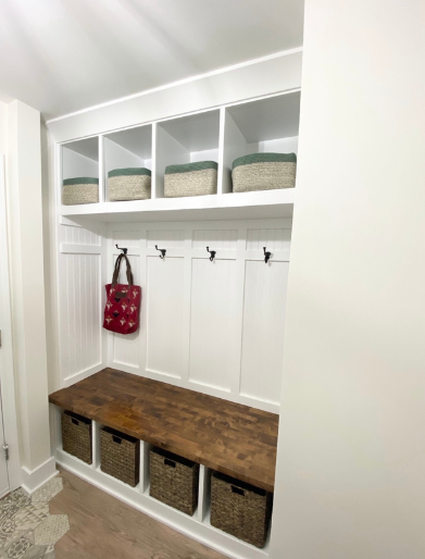 Custom mudroom locker system with bench seating, hooks, and built-in storage cubbies.