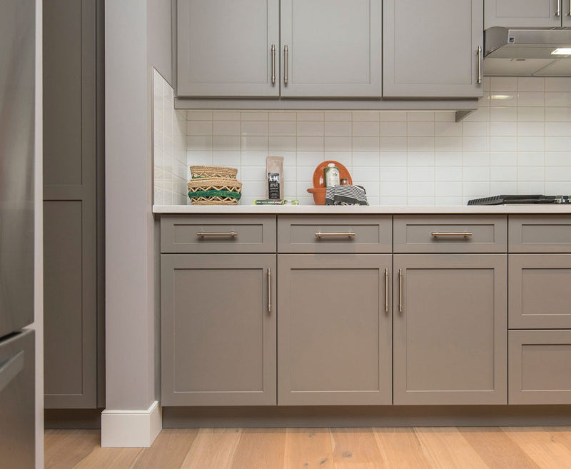 Rose Hill Cabinets gray shaker base and wall cabinets with brushed nickel hardware, white quartz countertop, and white square tile backsplash