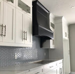 White shaker kitchen with Rose Hill cabinets, black custom range hood, textured tile backsplash, and polished quartz countertops.