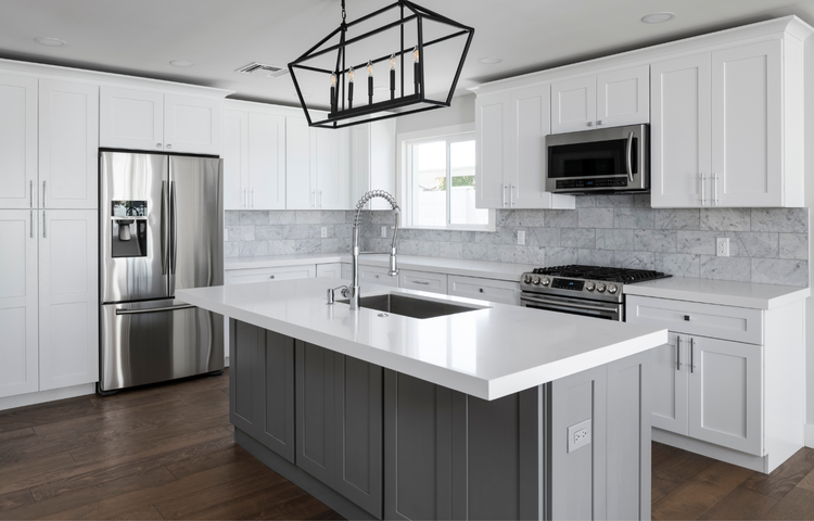 Two-tone kitchen with white shaker cabinets, gray island, white quartz countertop, marble tile backsplash, black lantern pendant light, and dark hardwood floors