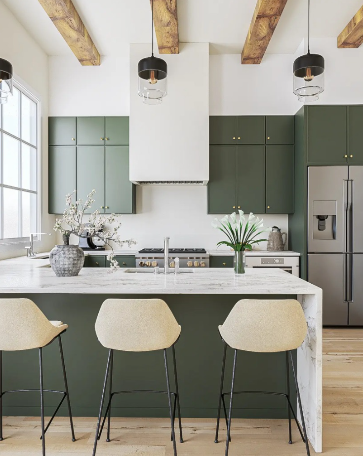 Modern farmhouse kitchen with olive green shaker cabinets, waterfall marble island, exposed wood beam ceiling, white range hood, and gold hardware