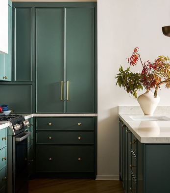 Rose Hill Cabinets deep green shaker tall pantry cabinet with gold hardware, drawer base, and marble countertop