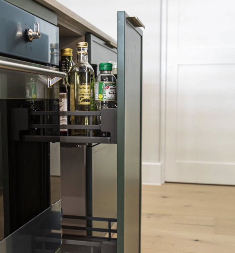 Green shaker base cabinet with pull-out spice and oil storage organizer