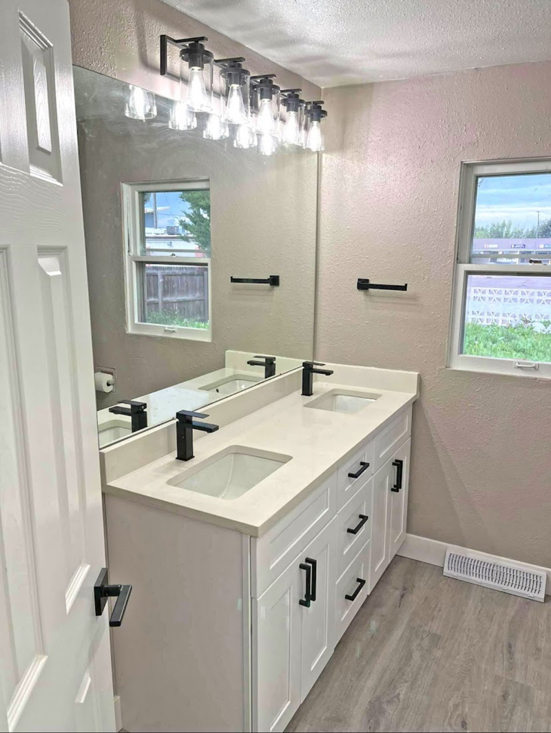 1:02 PM
Rose Hill Cabinets white shaker double vanity with white quartz countertop, dual undermount sinks, matte black faucets and hardware, and modern vanity light bar
