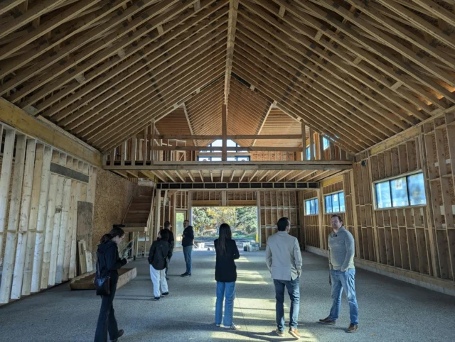 Homeowners and project team reviewing the framed interior of a new home