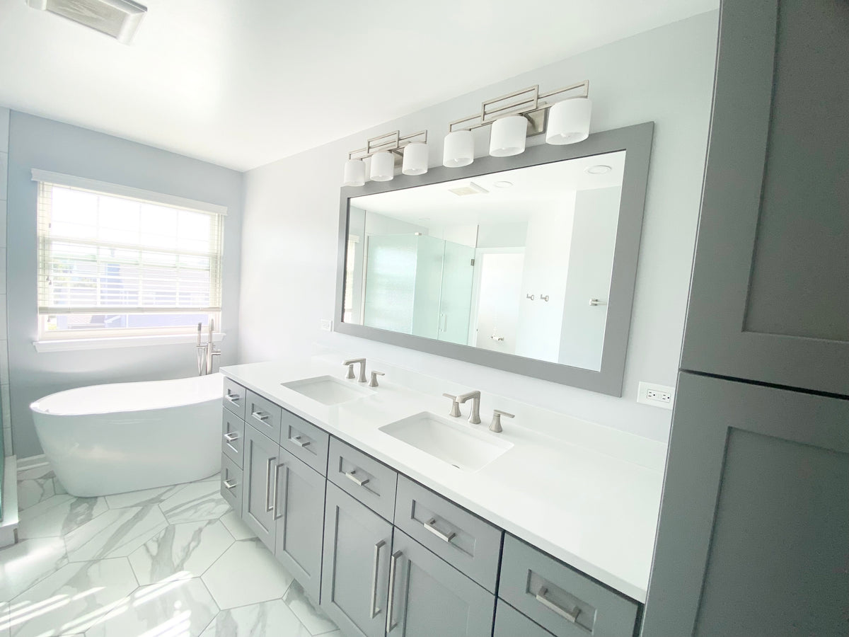 Rose Hill Signature Grey Shaker double vanity with white countertops beside a freestanding bathtub