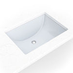 White porcelain rectangular undermount vanity sink shown in a bathroom scene