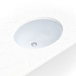 Compact white porcelain oval undermount vanity sink shown in a bathroom scene