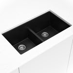 Matte black quartz double-bowl kitchen sink shown in a kitchen scene