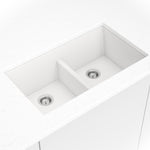 Matte white quartz double-bowl kitchen sink shown in a kitchen scene