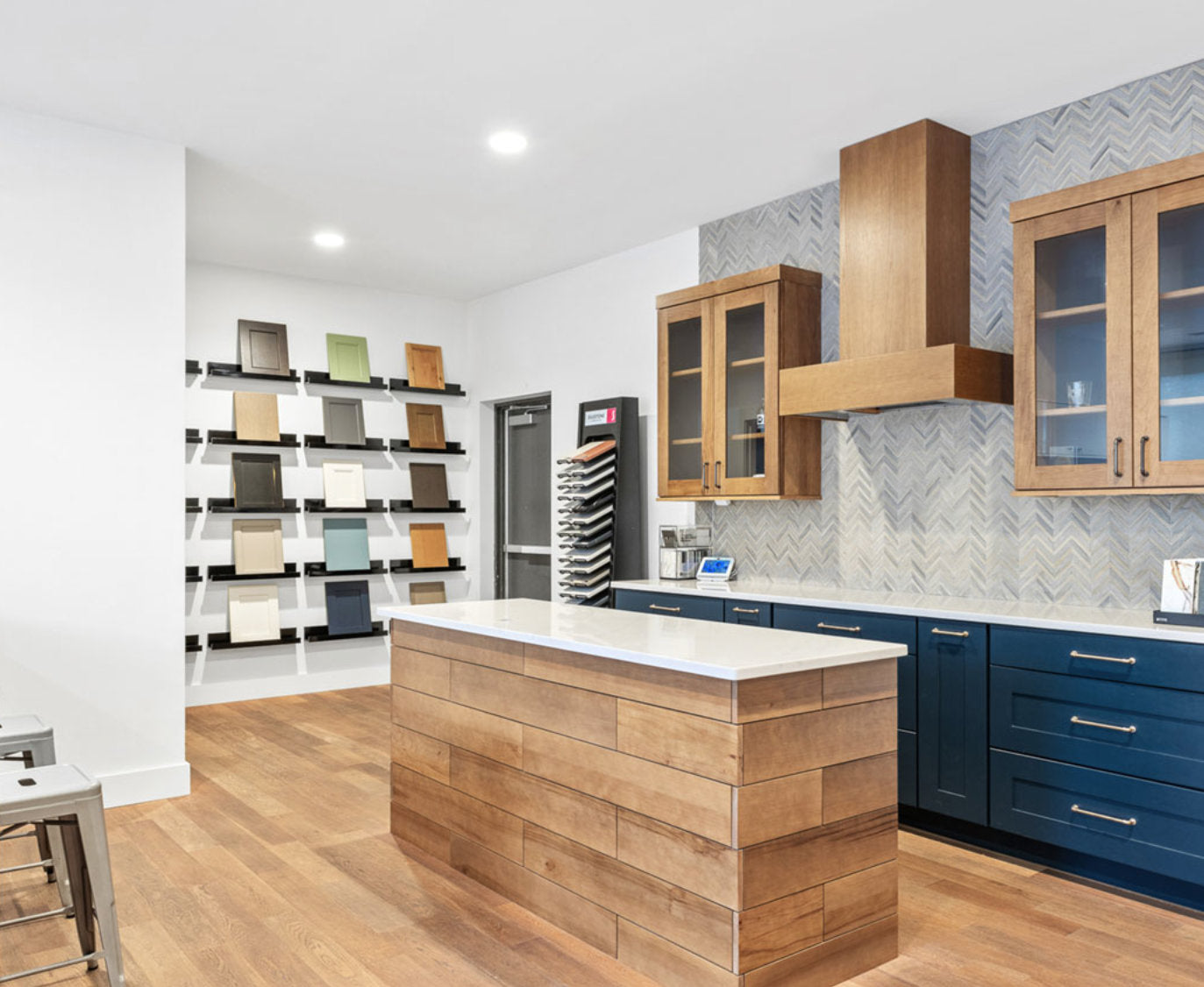 Modern showroom with wooden island and navy cabinets