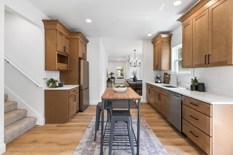 Kitchen cabinets with white quartz countertops, hardwood floors, and butcher block island
