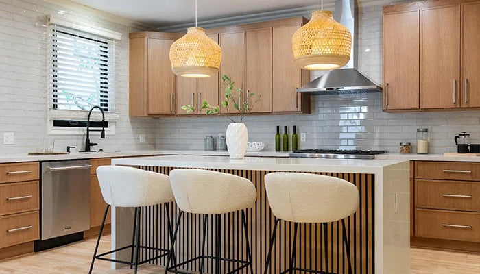 Modern kitchen with natural white oak shaker cabinets, fluted wood island, quartz countertop, gray subway tile backsplash, and woven rattan pendant lights
