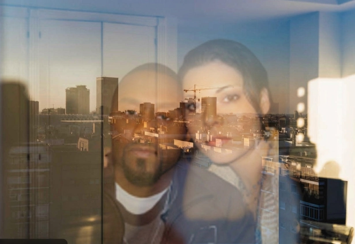 Camille and Marcus reflected in a city window before building their companies