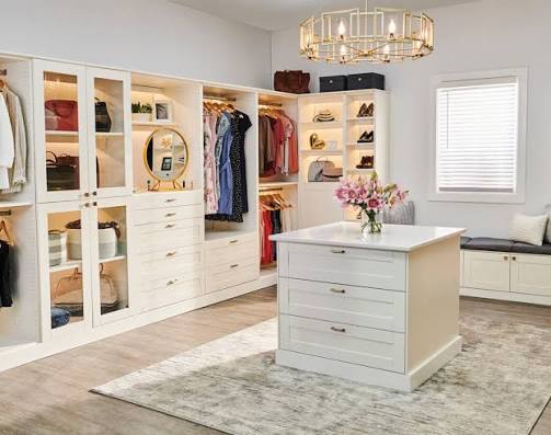 Built-in closet cabinetry with drawers and open storage